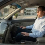 Man sitting in parked car outside a clinic, pausing before his annual physical exam appointment.
